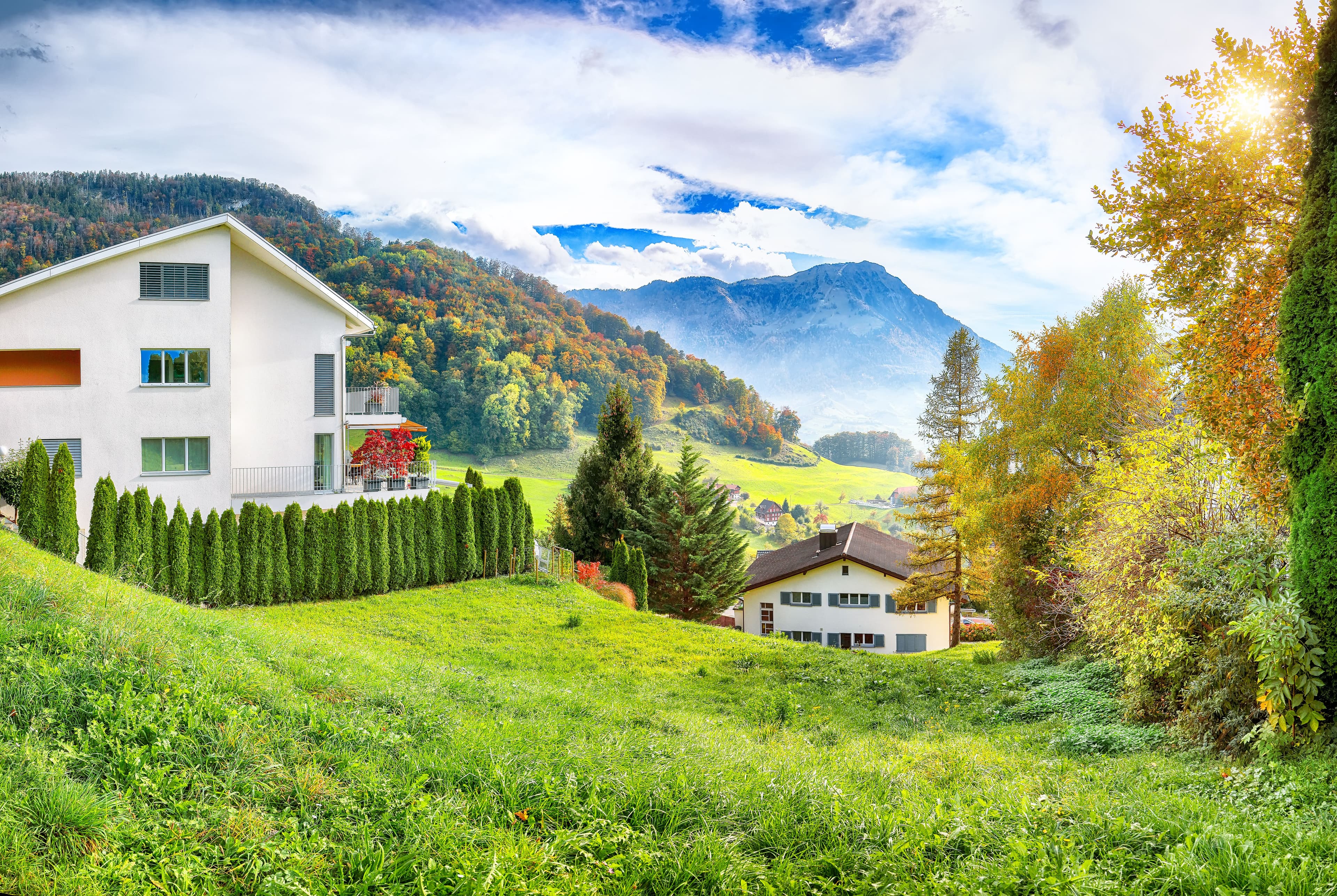 Exciting autumn view on suburb of Stansstad city and Lucerne lake with mountaines and fog