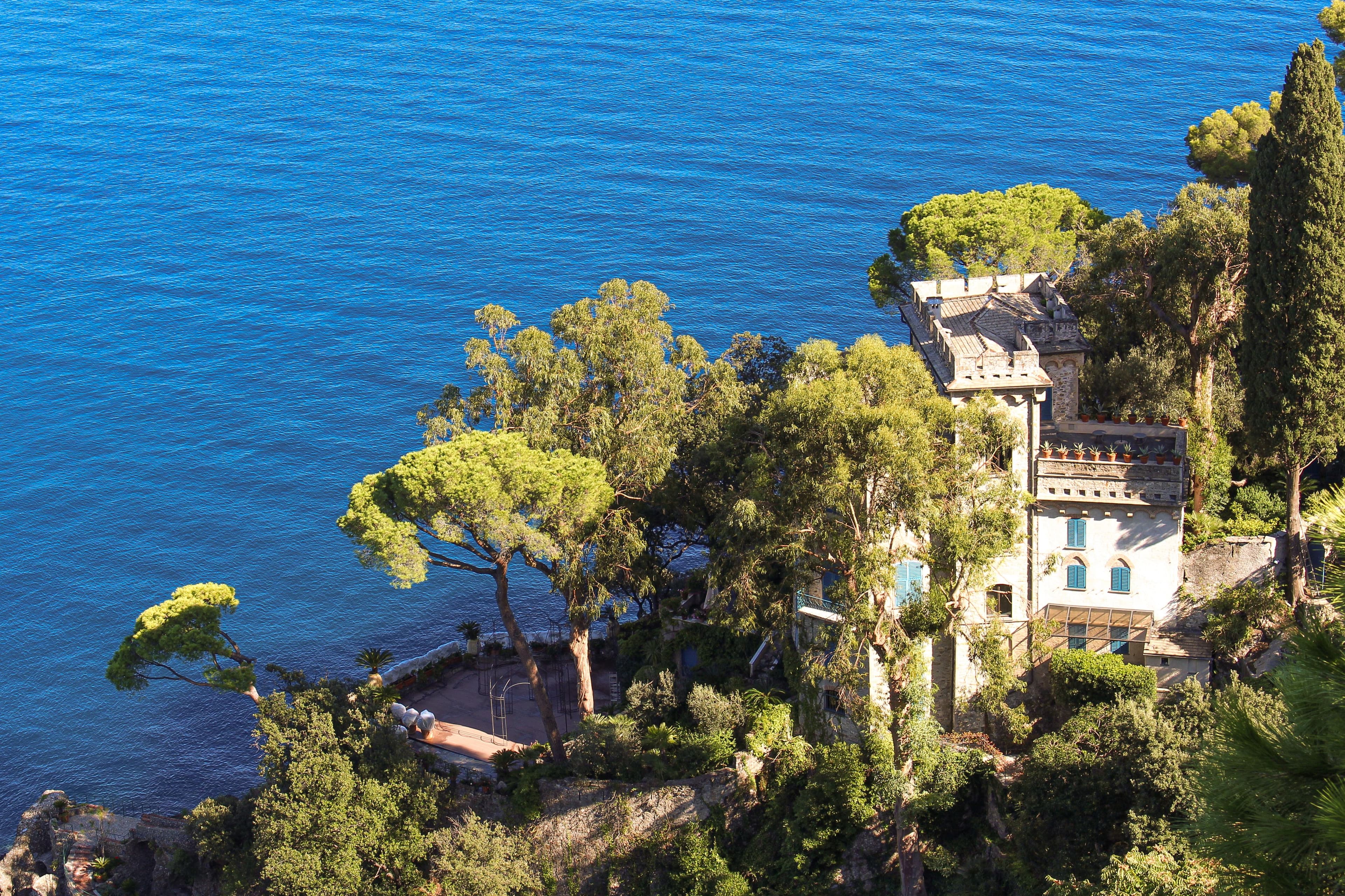Coastal Villa Surrounded by Green Trees on Cliffside