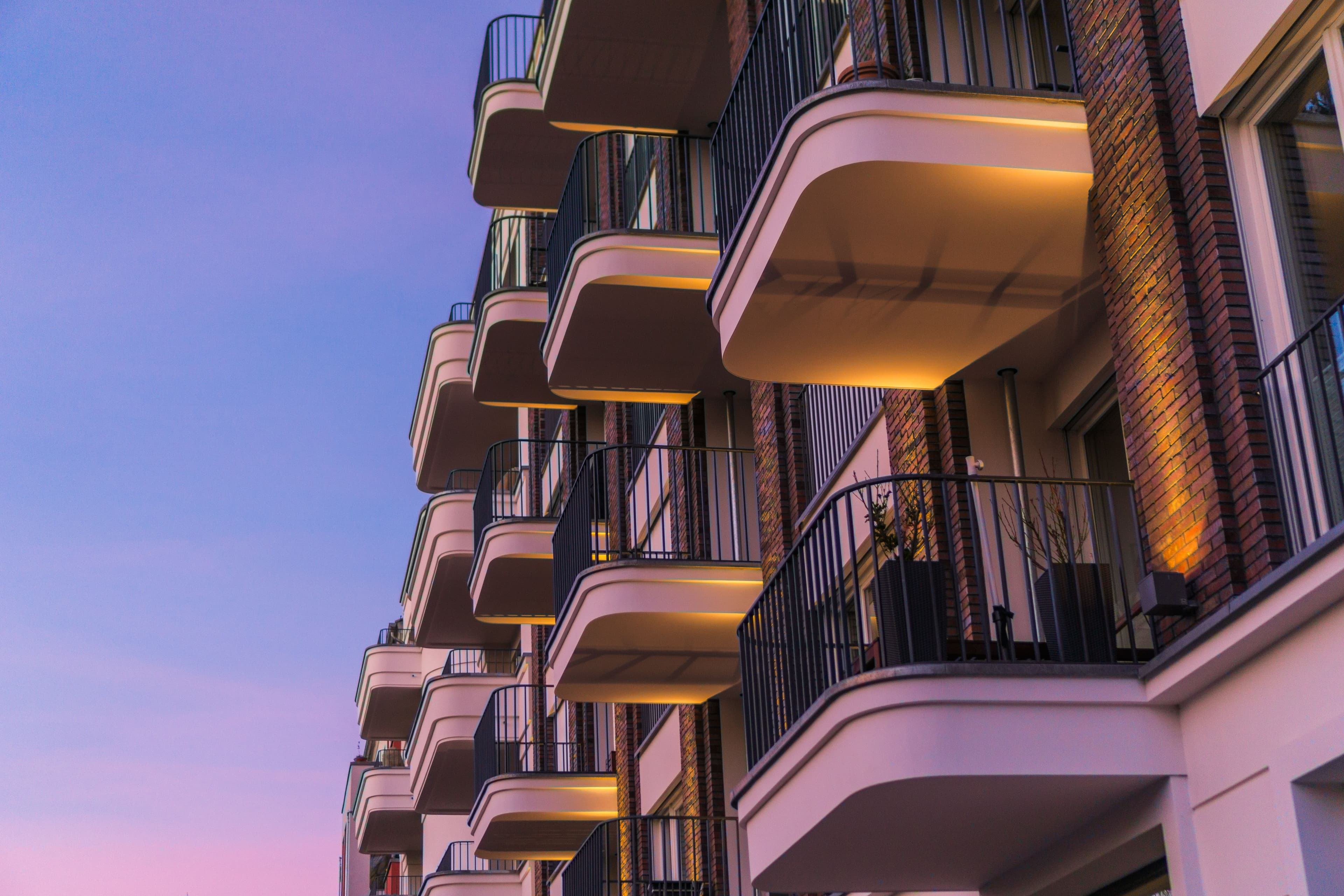 Modern And Curved Balcony On Brick Facade In The Afternoon