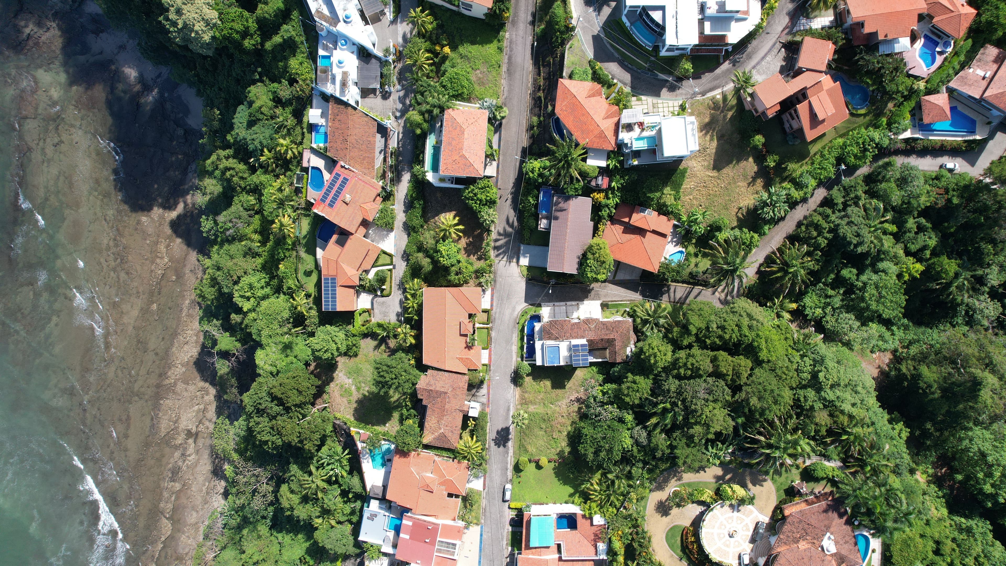 Aerial view of villas and a forest on the coast