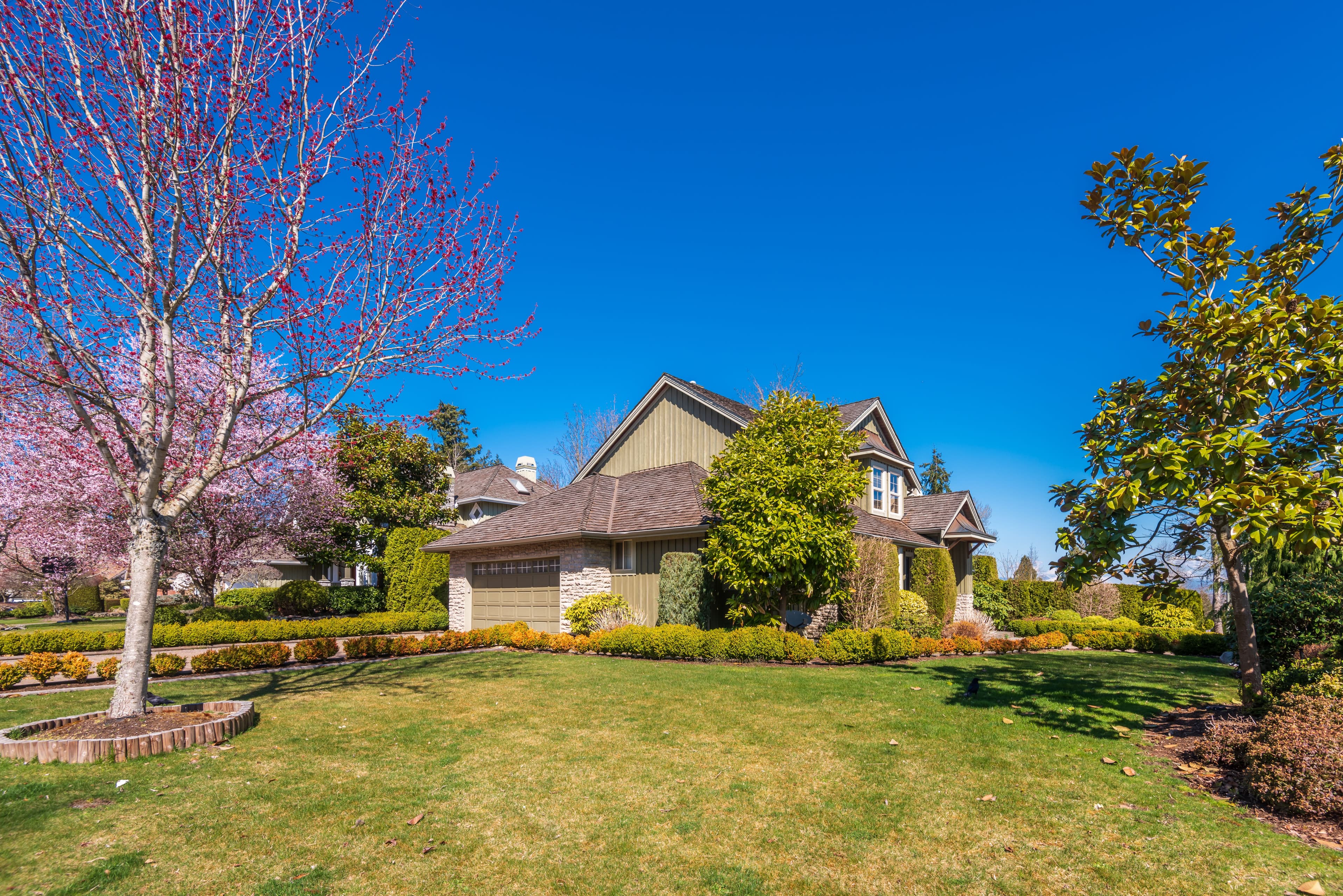 Beautiful Exterior Of Newly Built Luxury Home. Yard With Green Grass And Walkway Lead To Front
